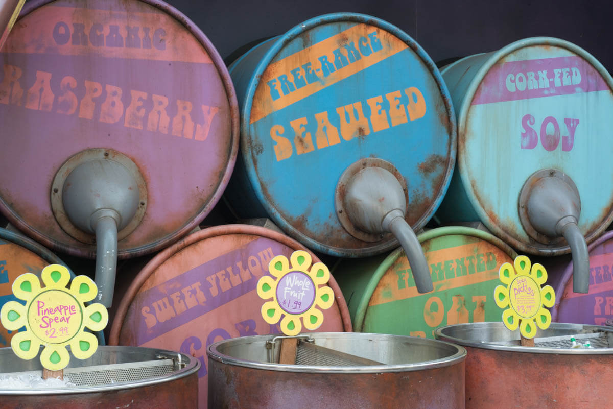 Old Oil Cans with Drink Labels: Raspberry, Seaweed, Soy Printed on Them at Disneyland's Cars Land
